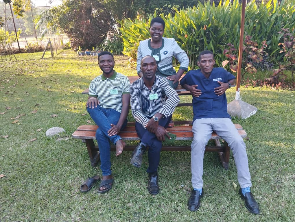 The facilitation team from Caring Heart Foundation together with the Public Health Officer of Kilombero Sugar Company, who is dressed in blue medical scrubs.
